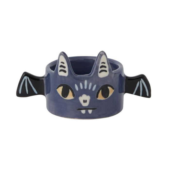 Cat-shaped container with bat wings on a white background