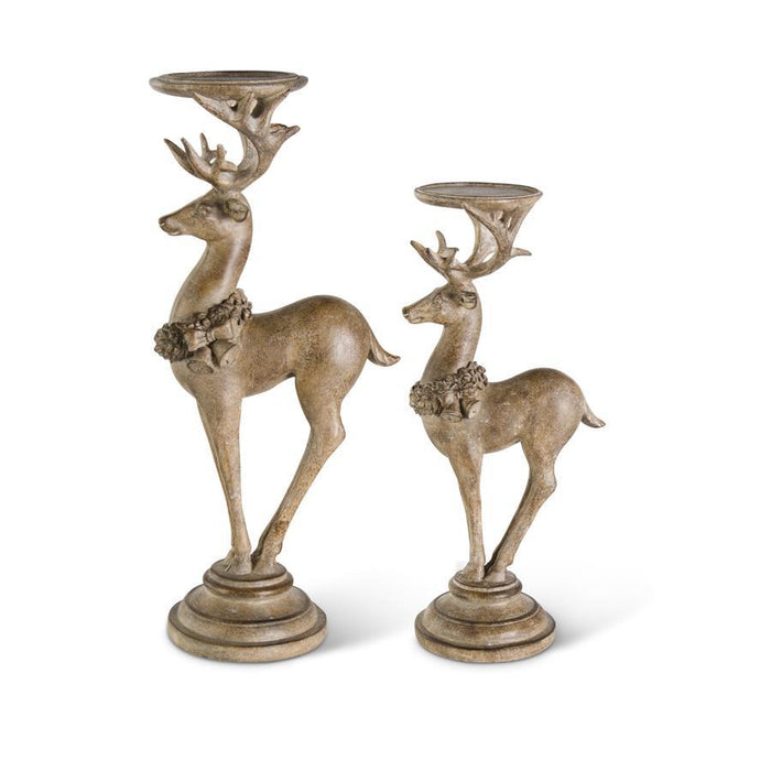 Two decorative deer candle holders on a white background