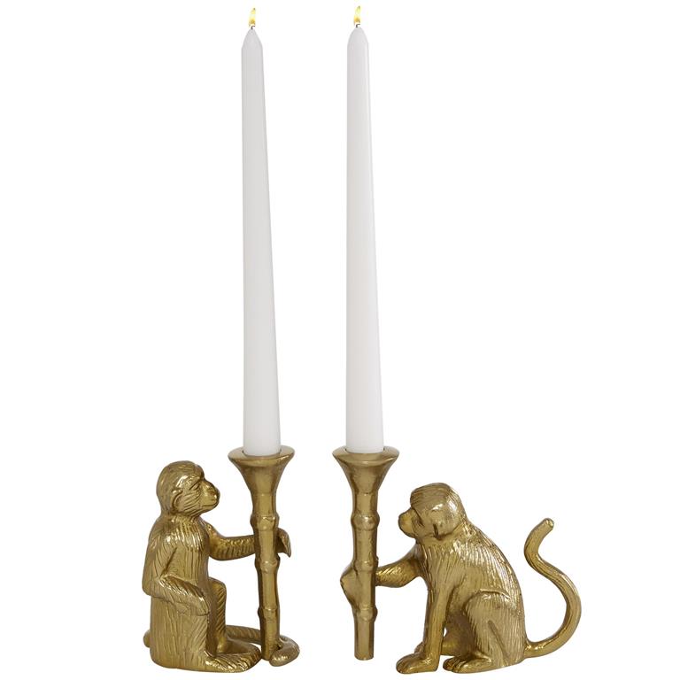 Two gold aluminum candle holders in the shape of monkeys holding candlesticks.