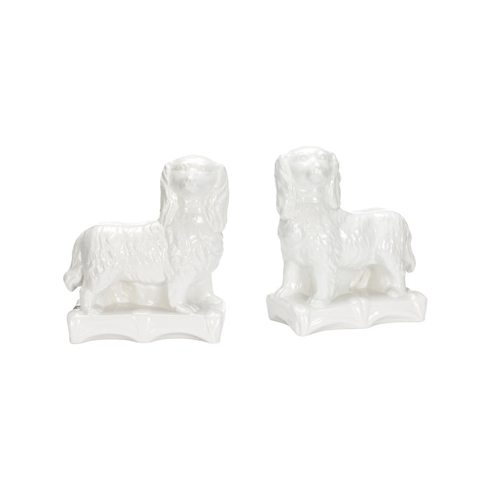Two white ceramic dog figurines on a white background