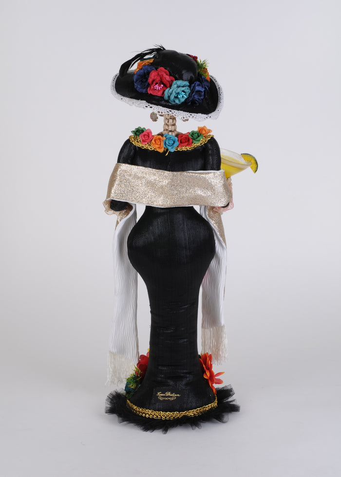 Decorative figure with colorful headpiece and floral details on a white background
