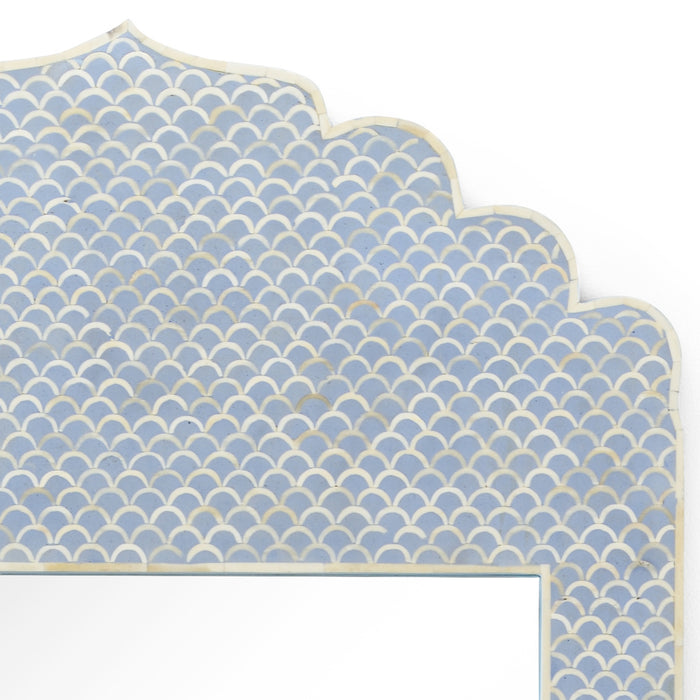 Decorative headboard with blue and beige fishscale pattern on a white background