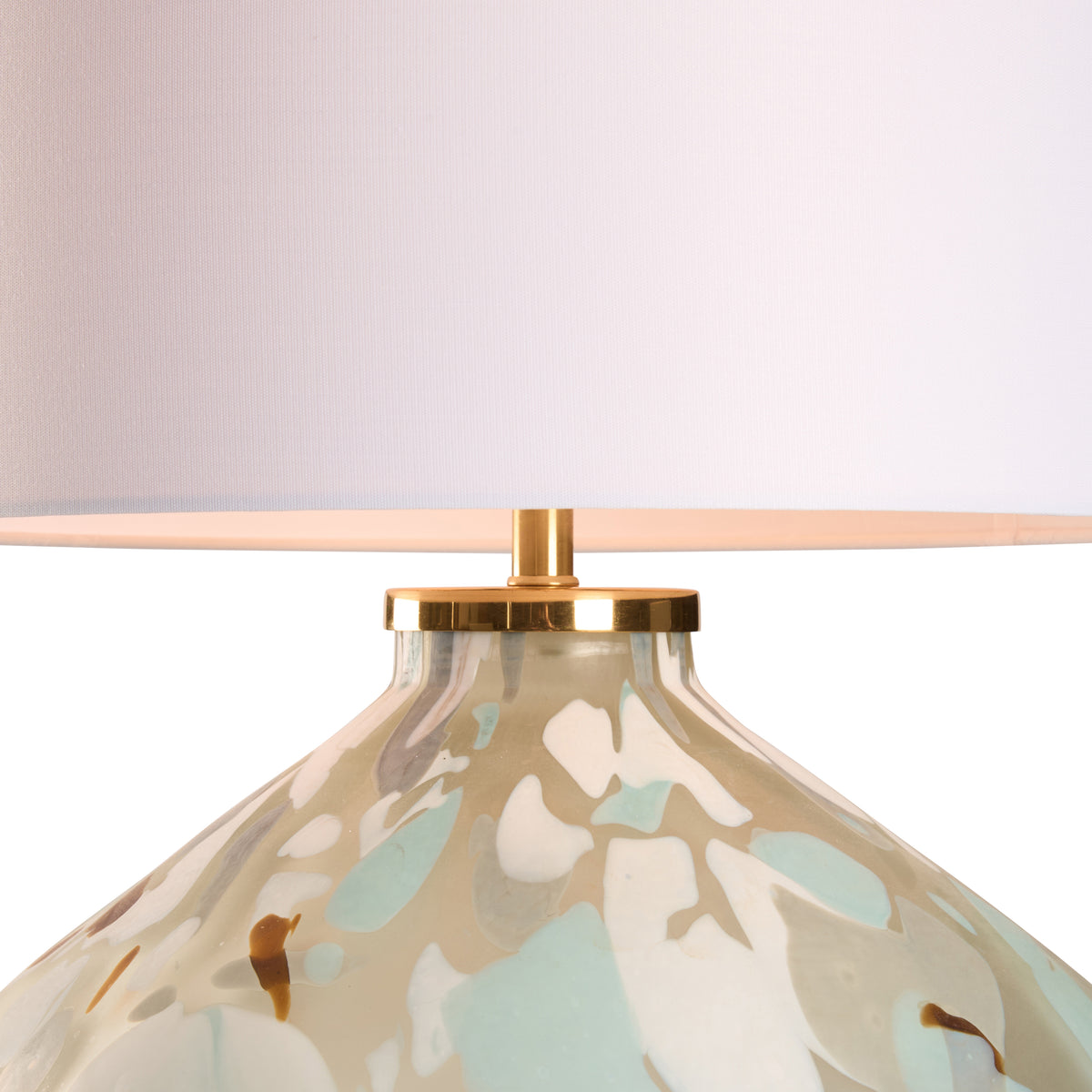 Decorative lamp with floral pattern and gold base on a white background