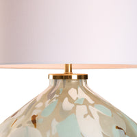 Decorative lamp with floral pattern and gold base on a white background