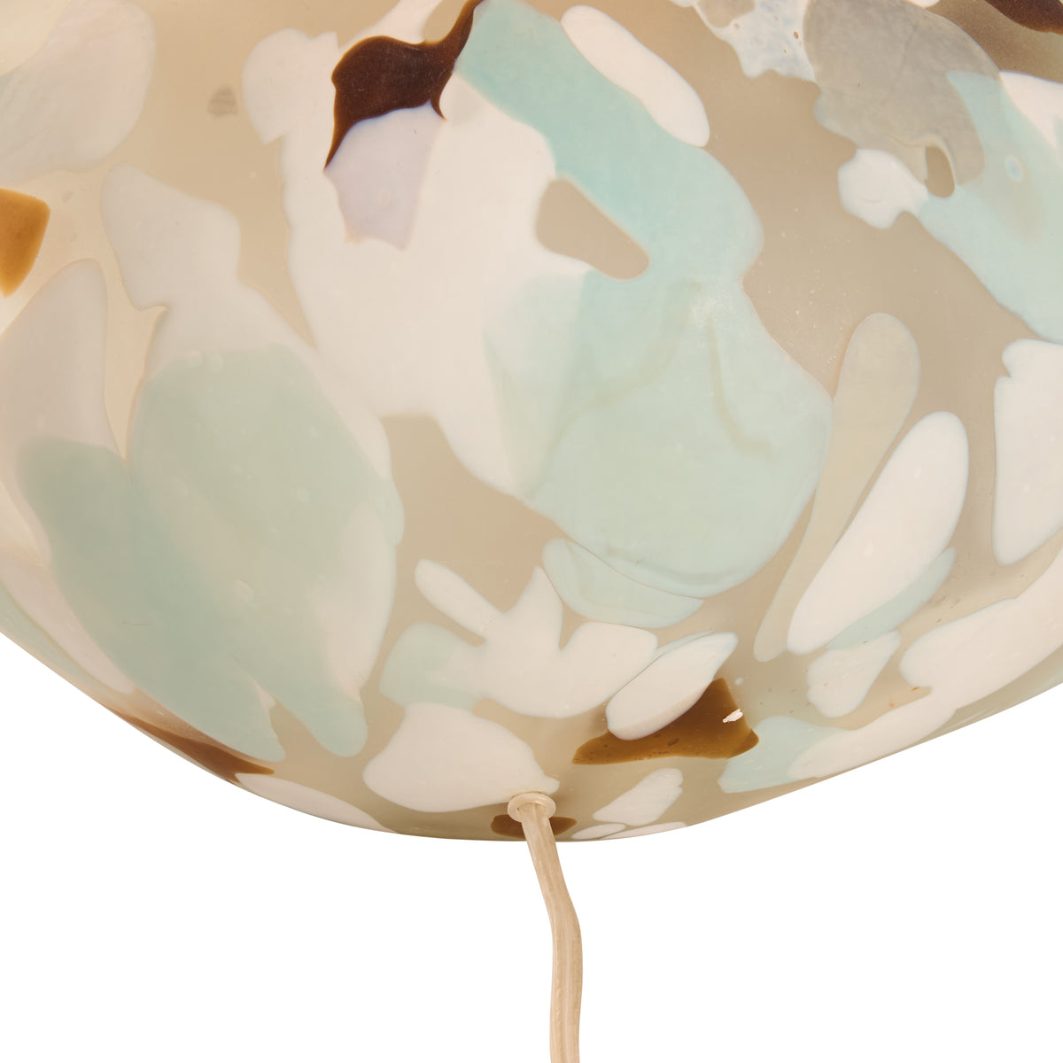 Decorative lampshade with abstract leaf pattern on a beige background
