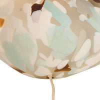 Decorative lampshade with abstract leaf pattern on a beige background