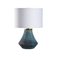 Table lamp with a blue ceramic base and white shade on a white background