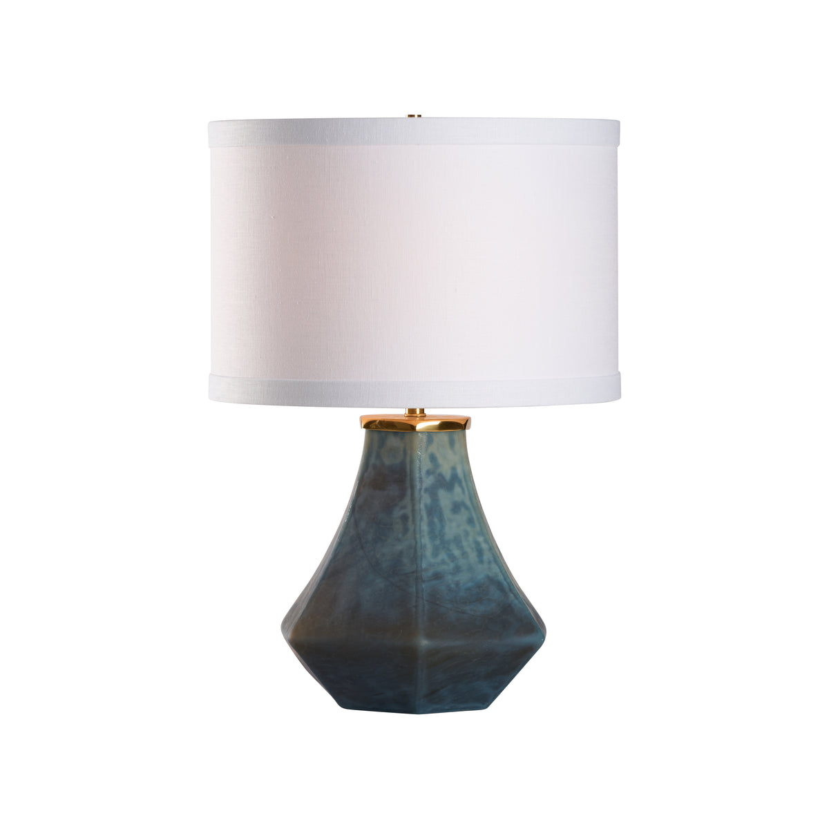 Table lamp with a geometric blue base and white shade on a white background