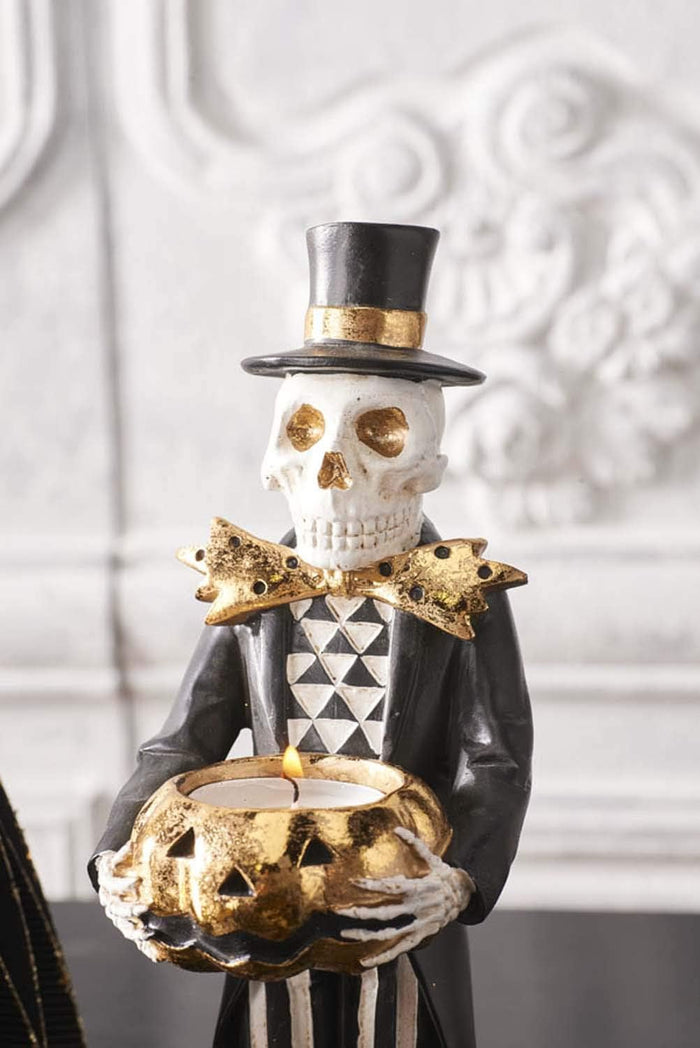 Design Shop 13 Inch Black and Gold Skeleton Holding Gold Jack O Lantern Pumpkin