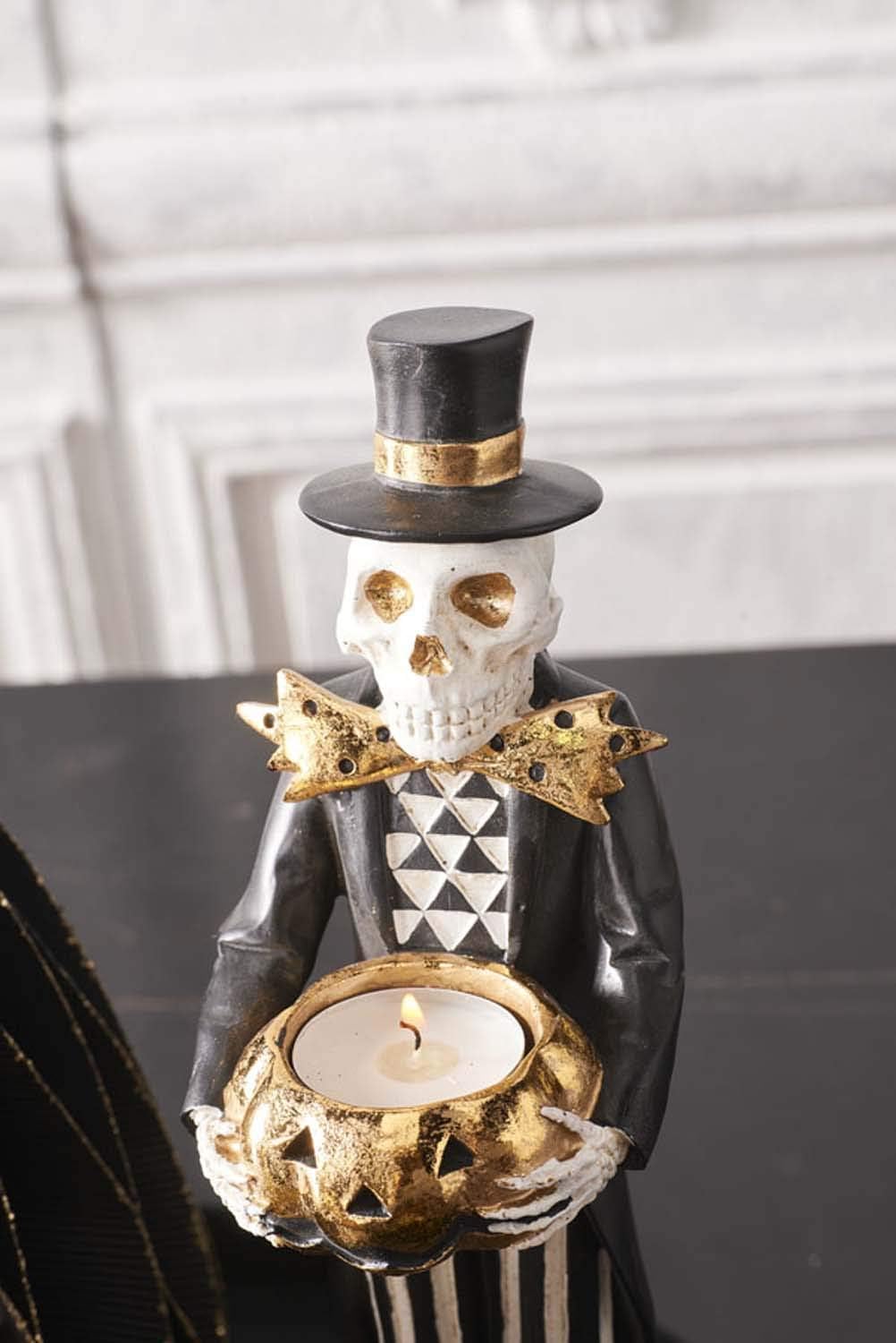 Design Shop 13 Inch Black and Gold Skeleton Holding Gold Jack O Lantern Pumpkin