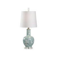 Decorative table lamp with a light blue base and white shade on a white background
