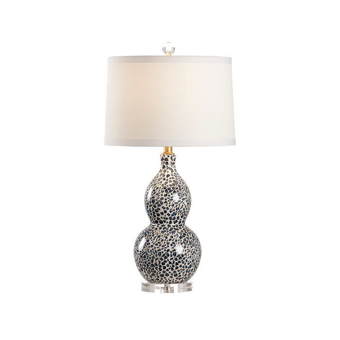 Decorative table lamp with a textured base on a white background