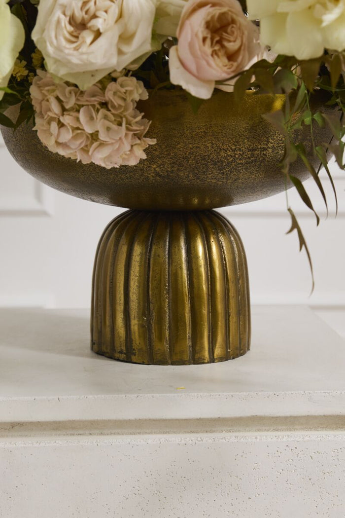 Decorative vase with floral arrangement on a white surface