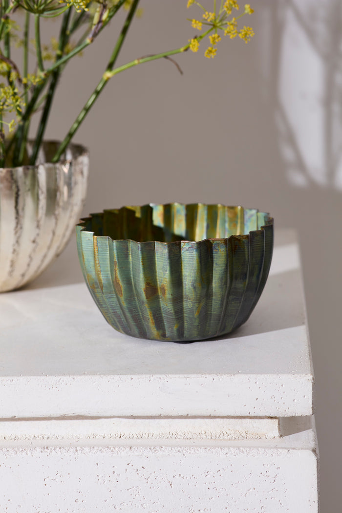 Decorative ceramic bowl with striped pattern on a light surface