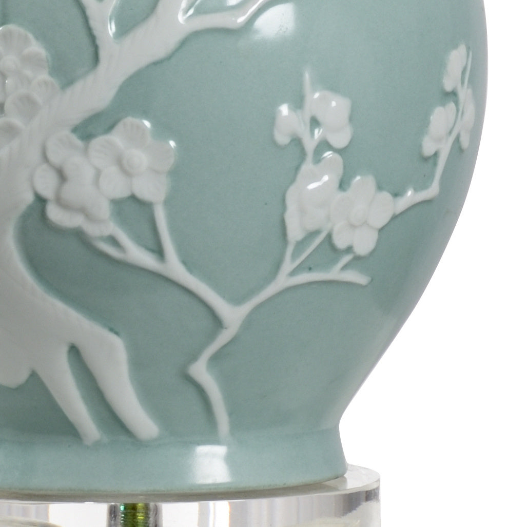 Light blue ceramic vase with white floral patterns on a clear background