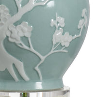 Light blue ceramic vase with white floral patterns on a clear background