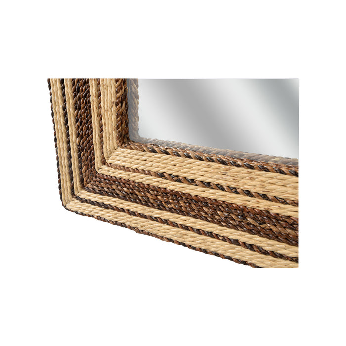 Close-up of a mirror with a woven brown frame on a white background