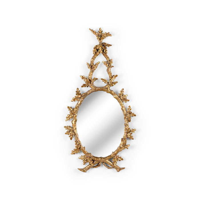 Decorative gold mirror with intricate design on a white background
