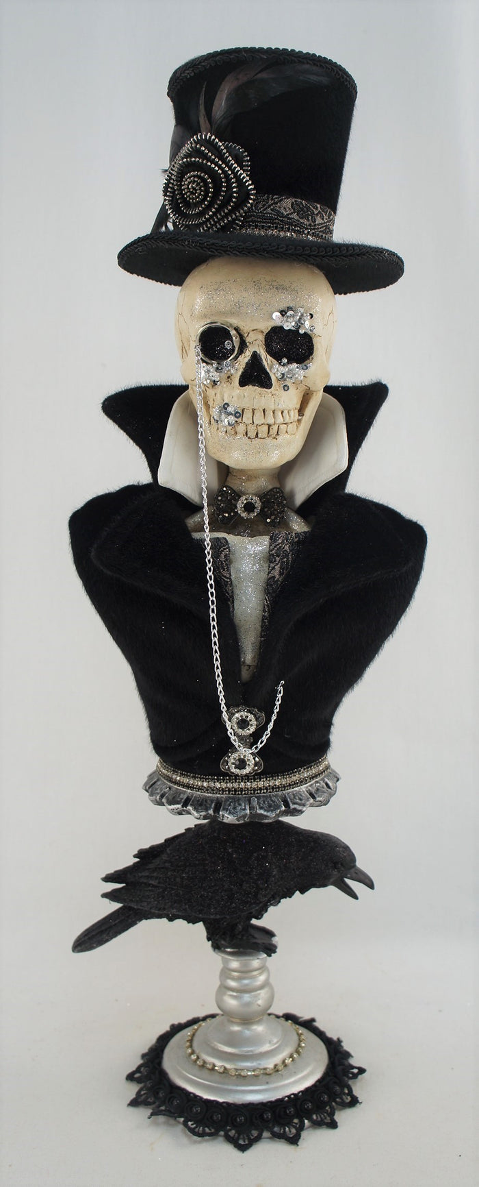 Skull wearing a top hat with decorative elements on a white background