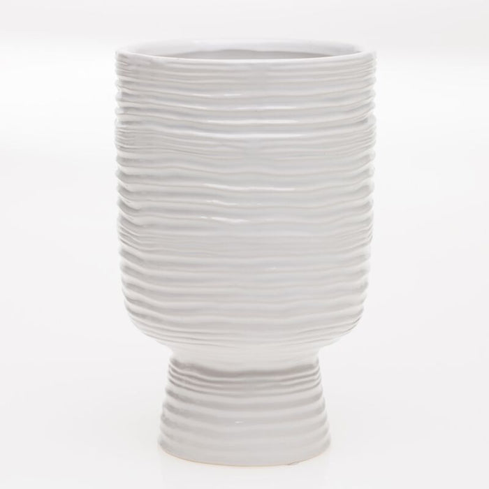 White ceramic vase with textured design on a white background
