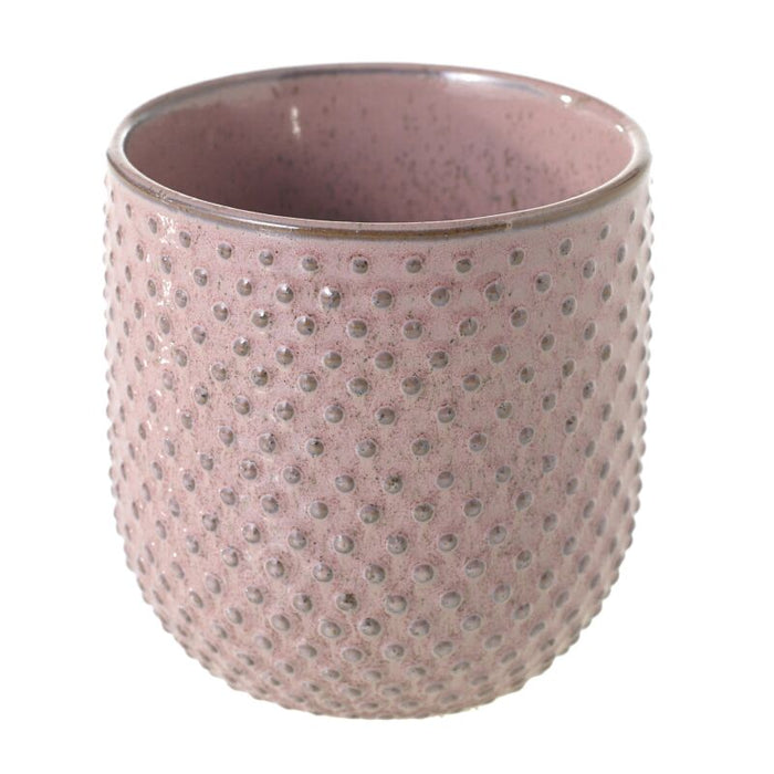 Pink textured ceramic cup on a white background