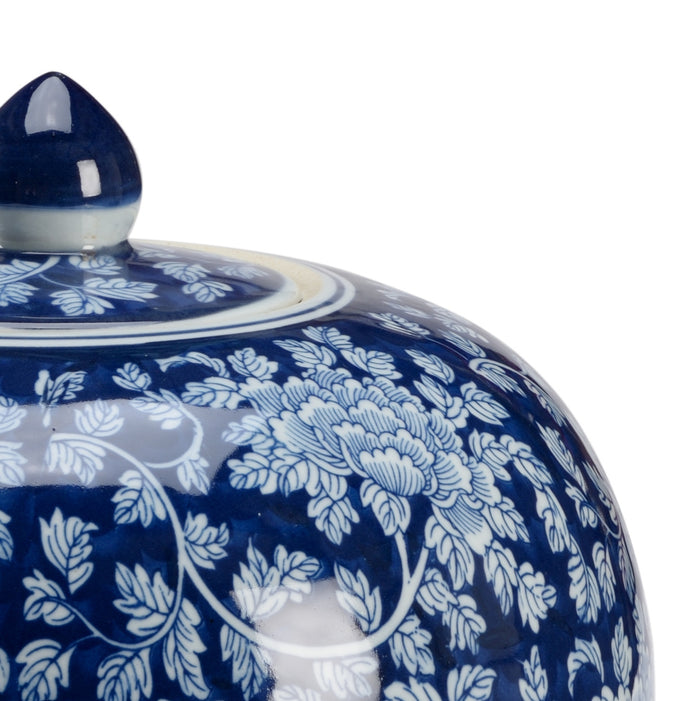 Ceramic jar with blue and white floral pattern on a white background