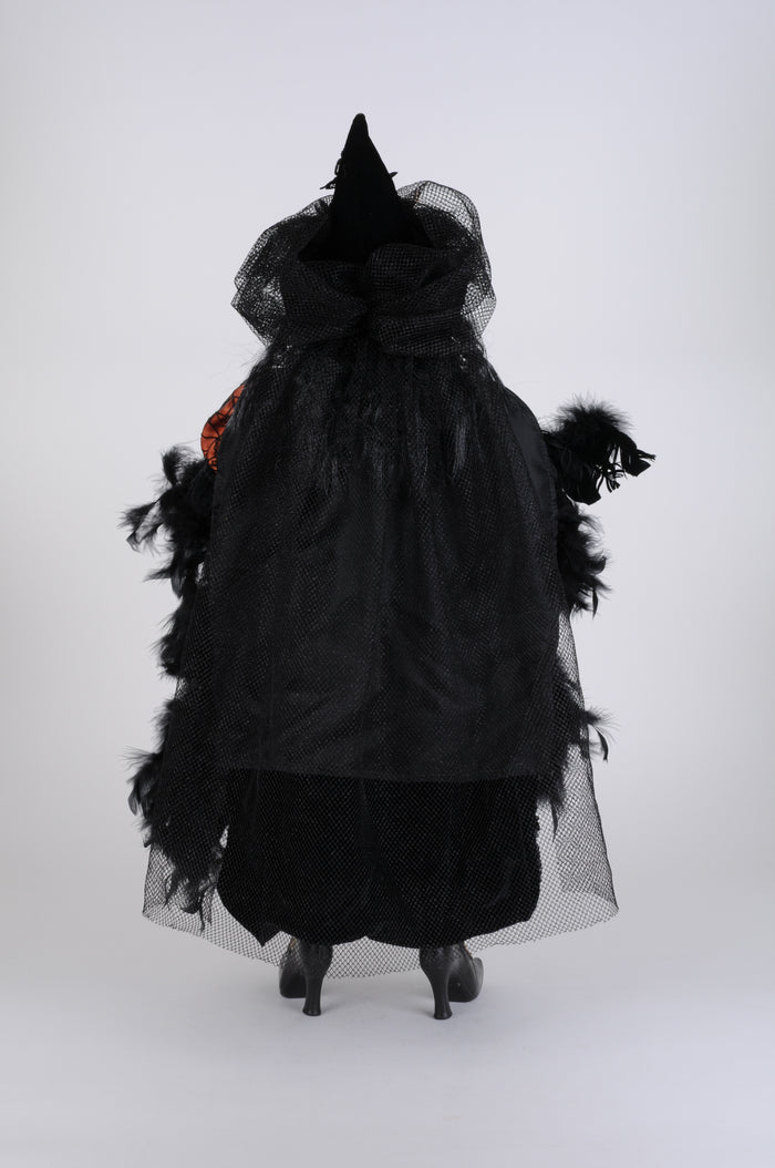 Black witch costume with a hat and gloves on a white background