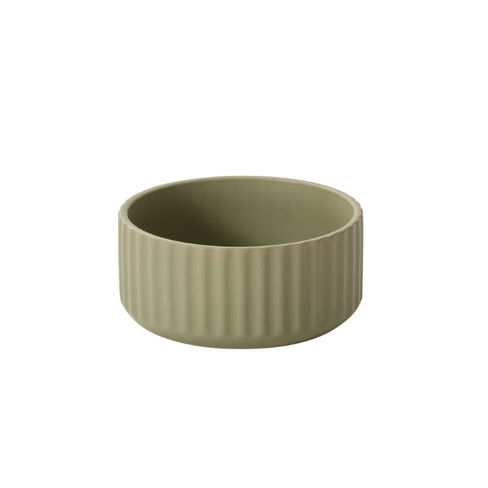 Green ceramic bowl with ribbed texture on a white background