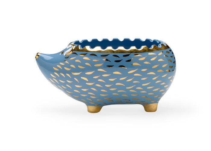 Blue ceramic bowl with gold leaf pattern on a white background