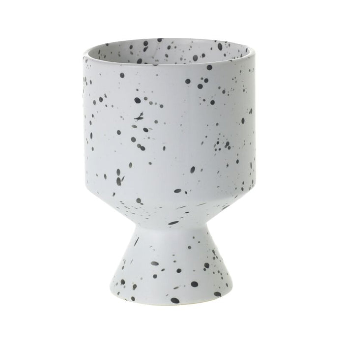 White ceramic planter with black speckles on a white background