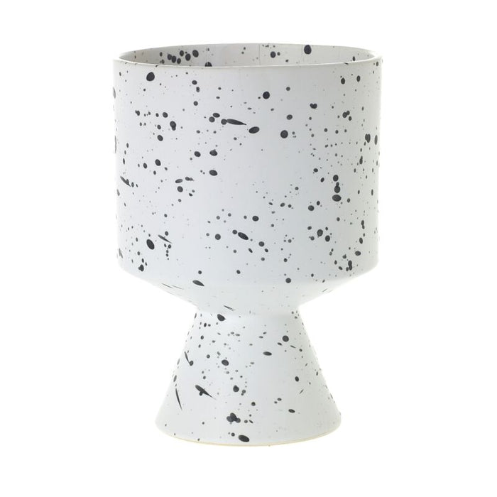 White ceramic planter with black speckles on a white background