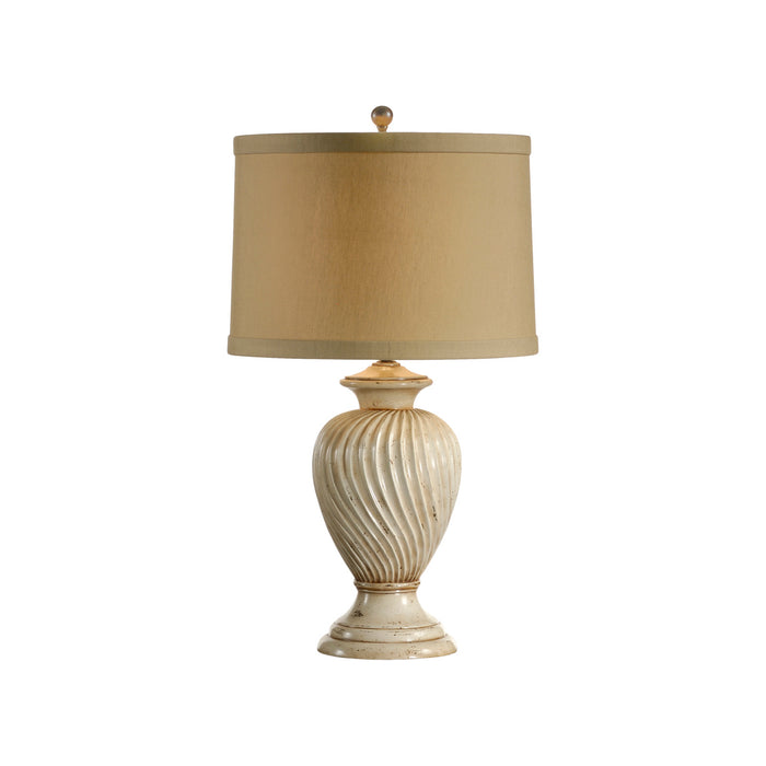 Table lamp with ribbed base and beige shade on a white background