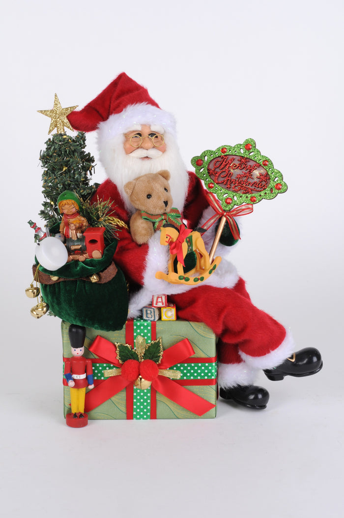 Decorative Christmas figure of Santa Claus with toys and gifts on a white background