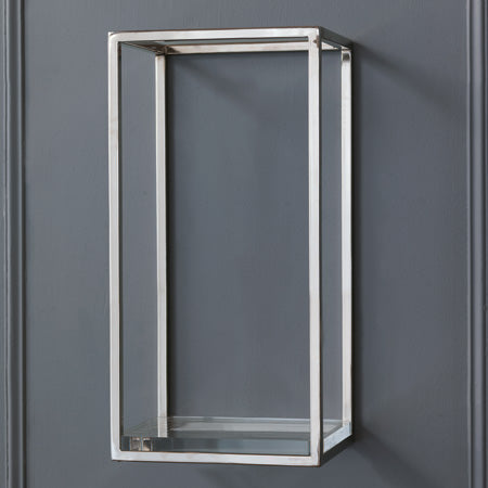 A polished nickel shelf with a clear acrylic bottom and metal supports mounted on a gray wall.