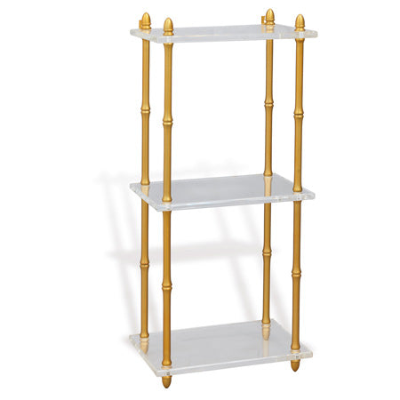 A three-tiered wall-mounted shelf with gold-colored bamboo-shaped turnings and white lucite shelves.