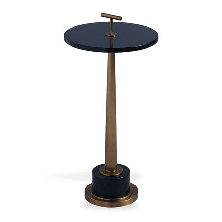 A modern tapered turned brass accent table with a black lucite top and granite base, featuring a T-shaped center pull.