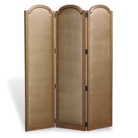 An upholstered three-panel screen with aged gold fabric and a maple wood frame.
