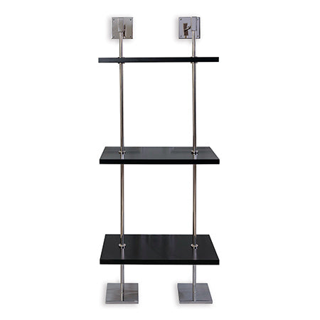 A modern multi-tier shelf unit with black MDF wood shelves and nickel finished metal poles, secured to the wall.