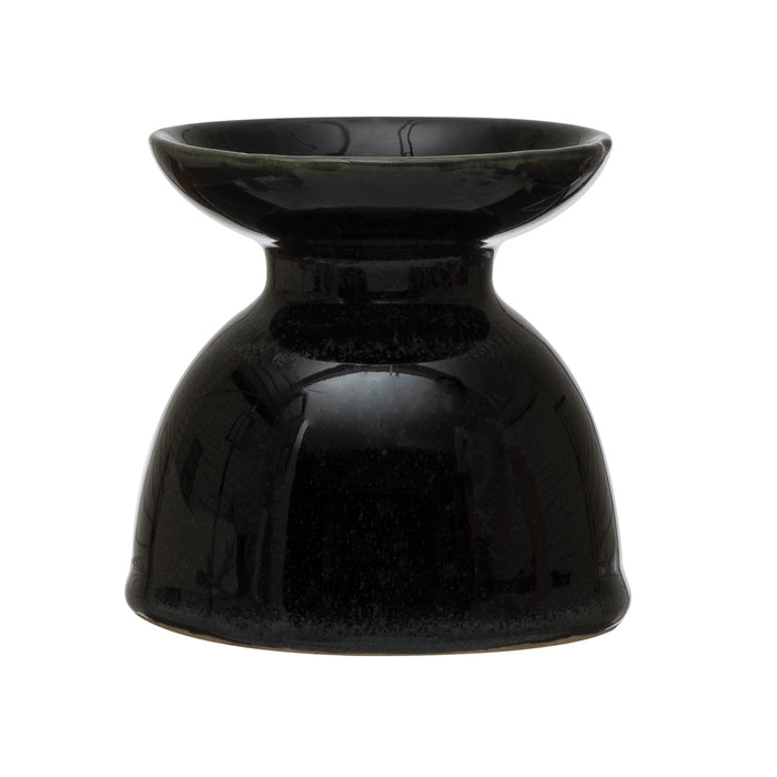 A black stoneware pillar candle holder with a shiny finish.