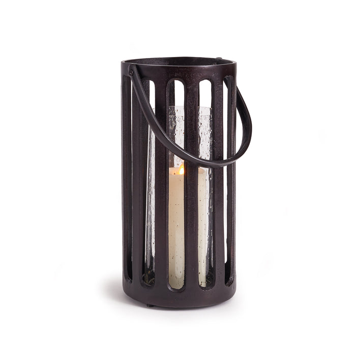 A black cast aluminum hurricane candle holder with a seeded glass insert and a side handle.