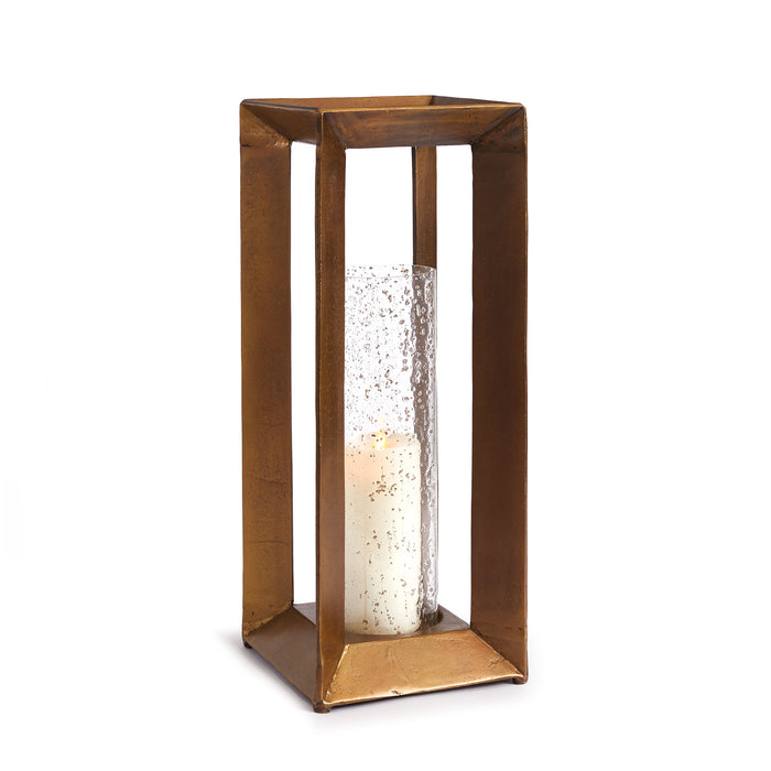 A tall rectangular cast aluminum hurricane with a seeded glass insert containing a candle, designed for indoor use.