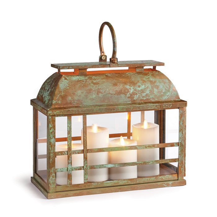 A small iron/glass lantern with a weather-worn patina, featuring an open top and candles inside.