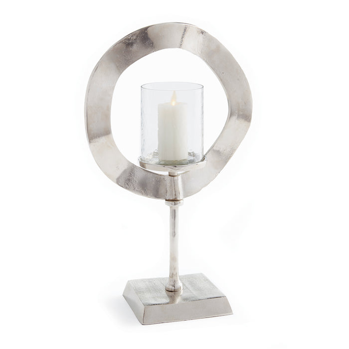 A silver-colored candle stand with a circular frame and a cylindrical holder, designed to support a candle in the center.