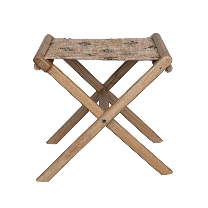 A folding stool made of mango wood with a jute kilim seat, featuring a sleek wood frame and intricate woven jute design.