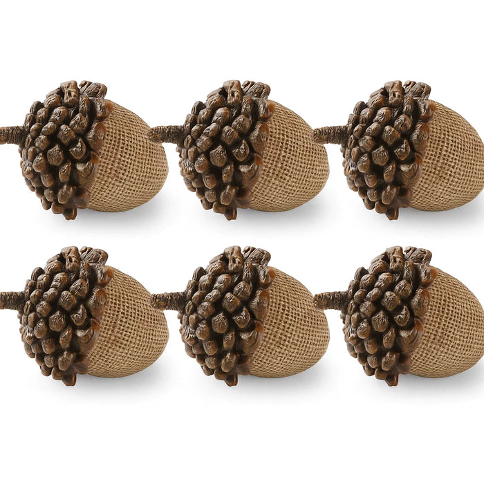Decorative acorn garland with brown and beige acorns on a white background