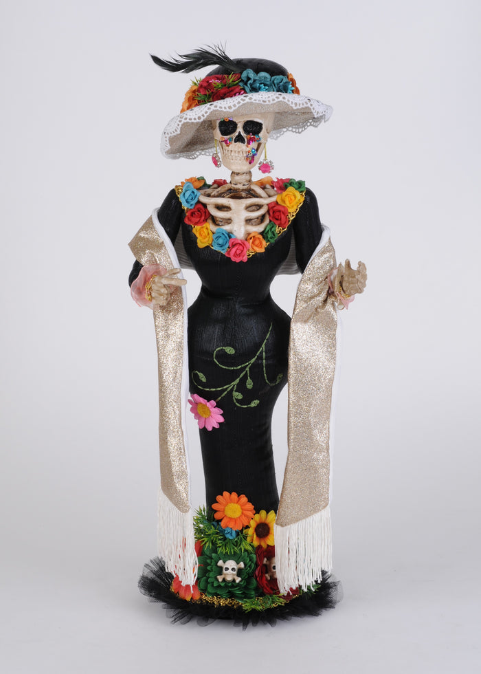 Decorative skeleton figure with colorful floral patterns on a plain background