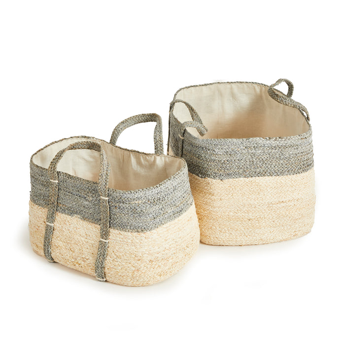 Two rectangular woven baskets, two-tone gray and natural straw, fabric-lined interiors, rope handles, on white background.