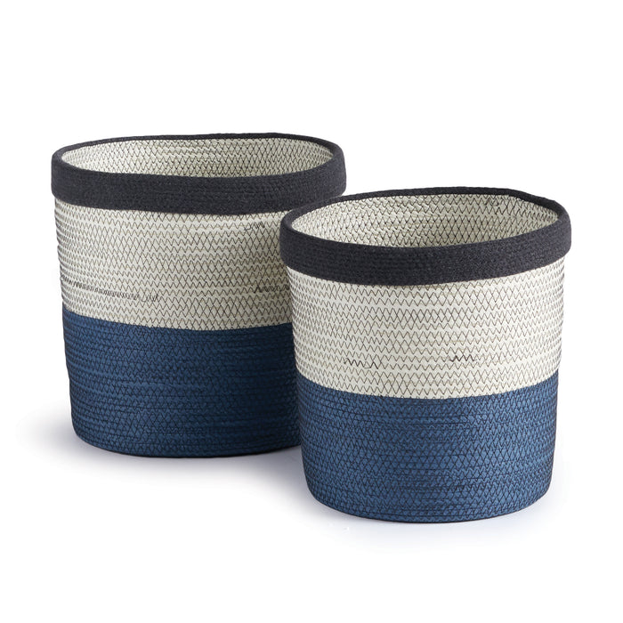 Two round wicker baskets with a geometric pattern, featuring a mix of white and navy colors.