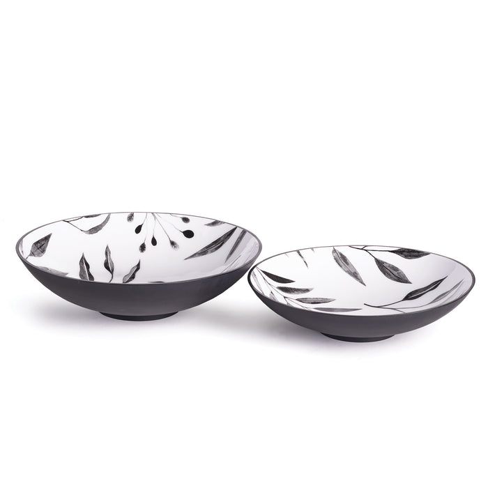 Set of two black-bottom ceramic bowls with white interiors featuring black leaf and branch patterns.