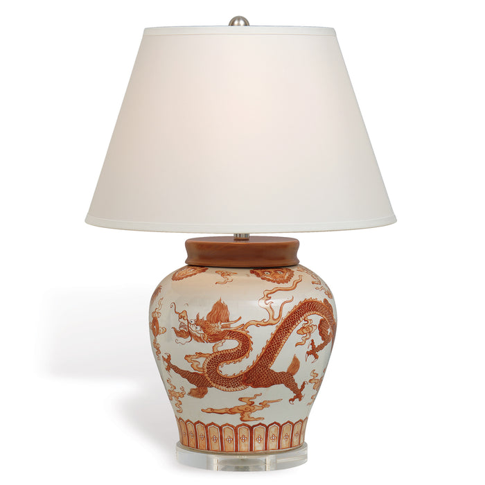 Decorative table lamp with a ceramic base featuring dragon designs on a white background.